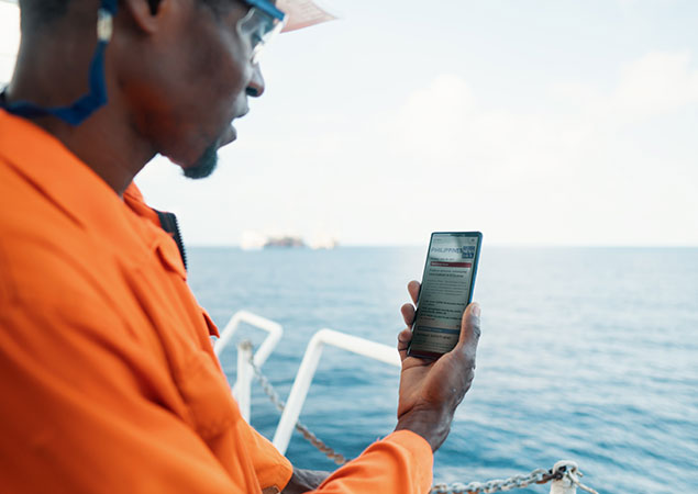 Crew Member on Mobile Phone Watching News